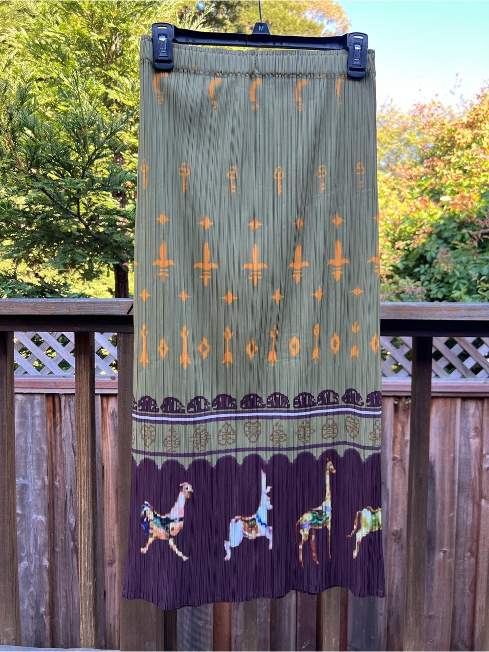 Pleated sage green print skirt with unicorn hem